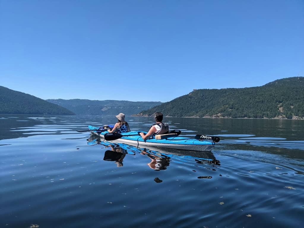 paddlers in kayaks in brentwood bay near victoria