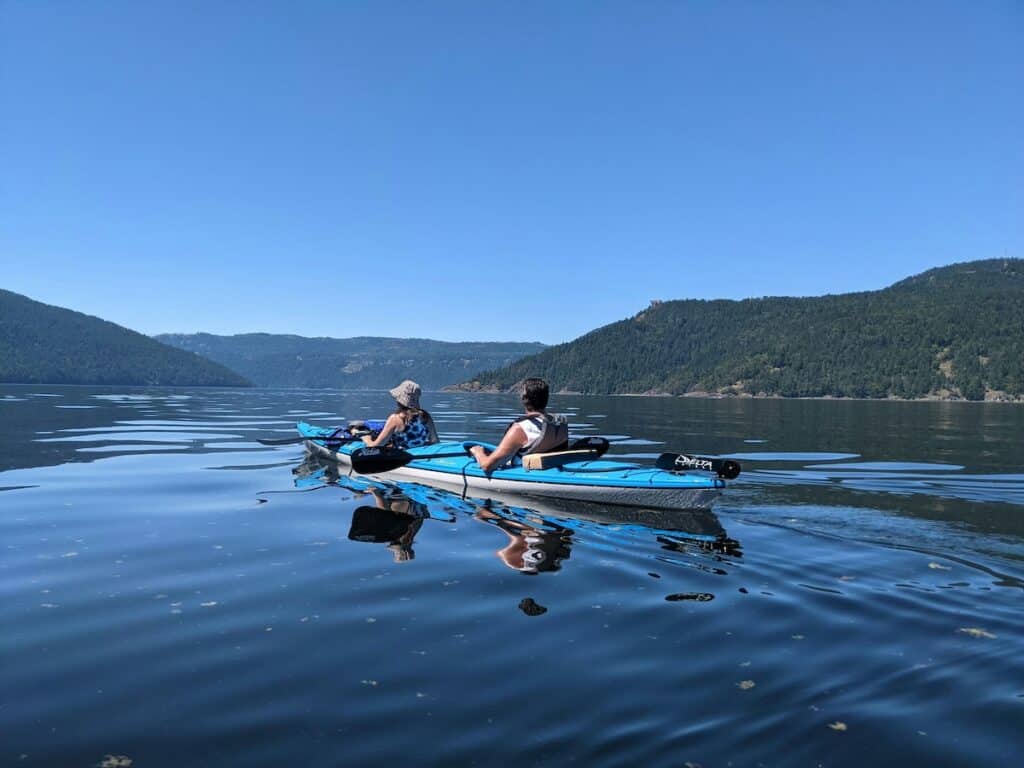 two paddlers in a double kayak near victoria bc