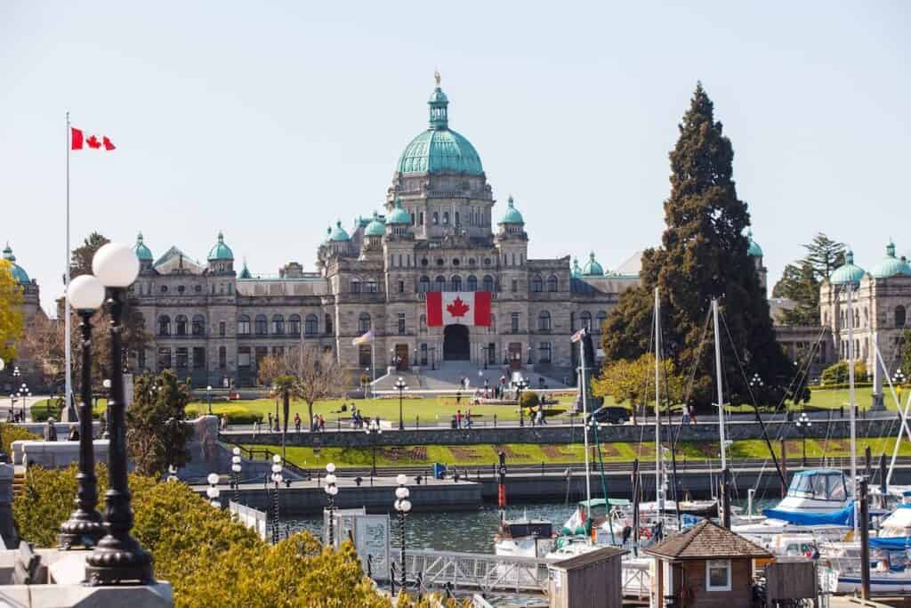 the Victoria BC legislature with the inner harbor in the foreground