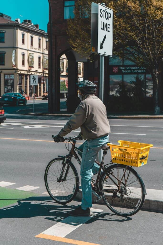 a cyclist travels through downtown victoria in a bike lane